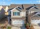 Charming townhome with a two-car garage, stone accents, neutral siding, and well-maintained landscaping at 5062 Gribble Ln, Lancaster, SC 29720