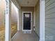 Inviting covered entryway with a black front door and a 'Welcome Home' mat at 5062 Gribble Ln, Lancaster, SC 29720