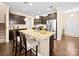Spacious kitchen featuring a granite island with seating, stainless steel appliances, and dark cabinets at 5062 Gribble Ln, Lancaster, SC 29720