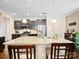 This kitchen features an island with bar stool seating, granite countertops, stainless appliances, and dark cabinetry at 5062 Gribble Ln, Lancaster, SC 29720