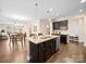 Open-concept kitchen with an island, stainless steel appliances, and seamless flow to the dining area at 5062 Gribble Ln, Lancaster, SC 29720