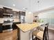Spacious kitchen featuring stainless appliances, granite countertops, dark wood cabinetry, and an island with bar stool seating at 5062 Gribble Ln, Lancaster, SC 29720
