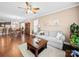 Inviting living room featuring hardwood floors and neutral decor, seamlessly connected to the dining area at 5062 Gribble Ln, Lancaster, SC 29720