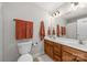 Clean bathroom featuring double sinks, ample counter space, and orange towels providing a vibrant pop of color at 516 King St, Waxhaw, NC 28173