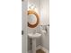 Stylish bathroom featuring a pedestal sink, decorative mirror, updated lighting, and tiled flooring at 516 King St, Waxhaw, NC 28173