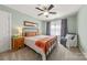 Relaxing bedroom with light blue walls, a ceiling fan, and large window with natural light and privacy curtains at 516 King St, Waxhaw, NC 28173