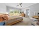 Bright primary bedroom with lots of natural light, view of backyard, ensuite bathroom and walk-in closet at 516 King St, Waxhaw, NC 28173