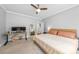 Primary bedroom with a ceiling fan, a desk for work or study, and a doorway leading to a closet and bathroom at 516 King St, Waxhaw, NC 28173