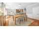 Sunlit dining room with an open floor plan flowing into the kitchen and bar seating at 516 King St, Waxhaw, NC 28173