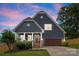 Charming home showcasing a well-manicured lawn, covered porch with columns, and attached garage at 516 King St, Waxhaw, NC 28173