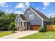 Beautiful home featuring an attached garage, landscaped yard, and classic architectural details at 516 King St, Waxhaw, NC 28173