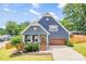Attractive home with brick accents, an attached garage, a well-maintained lawn, and a charming front porch at 516 King St, Waxhaw, NC 28173