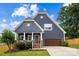Charming home showcasing a well-manicured lawn, covered porch with columns, and attached garage at 516 King St, Waxhaw, NC 28173