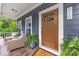 Inviting covered porch with comfortable seating, decorative plants, and a charming front door at 516 King St, Waxhaw, NC 28173