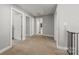 Hallway with multiple doors and neutral carpet throughout the floor plan leading to the bathroom and various bedrooms at 516 King St, Waxhaw, NC 28173