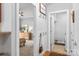 Hallway featuring a bedroom, laundry room, coat hooks, and a small decorative shelf at 516 King St, Waxhaw, NC 28173