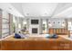Bright living room featuring a cozy fireplace, large windows, hardwood floors, and stylish decor at 516 King St, Waxhaw, NC 28173
