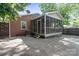 Exterior view of a brick home featuring a screened-in porch and ample parking space in backyard at 534 W Kingston Ave, Charlotte, NC 28203
