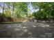 Backyard featuring a spacious concrete parking area and cozy outdoor seating area for entertaining at 534 W Kingston Ave, Charlotte, NC 28203