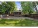 A beautifully maintained backyard with a screened-in porch and spacious concrete parking area at 534 W Kingston Ave, Charlotte, NC 28203