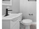 Modern bathroom featuring a sleek black faucet and white fixtures at 534 W Kingston Ave, Charlotte, NC 28203