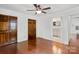 Bedroom with hardwood floors, ceiling fan and an attached bathroom at 534 W Kingston Ave, Charlotte, NC 28203