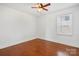 Bedroom with hardwood floors, white walls, and a ceiling fan at 534 W Kingston Ave, Charlotte, NC 28203