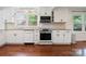 Well-equipped kitchen featuring stainless steel appliances, white cabinetry, and modern lighting at 534 W Kingston Ave, Charlotte, NC 28203