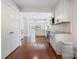 Spacious kitchen with hardwood floors, white cabinetry, stainless steel appliances, and open layout at 534 W Kingston Ave, Charlotte, NC 28203