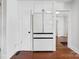 Modern kitchen with ample storage, featuring sleek white cabinetry and stainless steel refrigerator at 534 W Kingston Ave, Charlotte, NC 28203