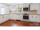 Bright kitchen with granite countertops, white cabinetry, and stainless steel appliances at 534 W Kingston Ave, Charlotte, NC 28203