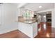 Modern kitchen with white cabinets, granite countertops, stainless steel appliances, and a breakfast bar at 534 W Kingston Ave, Charlotte, NC 28203