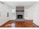 Spacious living room with a gray brick fireplace and hardwood floors at 534 W Kingston Ave, Charlotte, NC 28203