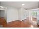Bright living room with hardwood floors, closet, and views into the kitchen with white cabinetry at 534 W Kingston Ave, Charlotte, NC 28203