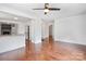 Open-concept living area with hardwood floors, seamlessly connected to a bright kitchen with white cabinetry at 534 W Kingston Ave, Charlotte, NC 28203