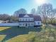 Aerial view of the two-story home with a pool, lush lawn, surrounding trees and landscaping at 5413 Austin Rd # 4, Monroe, NC 28112