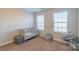 Sunlit bedroom featuring a crib, two windows, and cozy chair; perfect for a Bedroom at 5413 Austin Rd # 4, Monroe, NC 28112