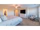 Comfortable primary bedroom features a ceiling fan, a sitting area, and ample closet space for organized storage at 5413 Austin Rd # 4, Monroe, NC 28112