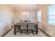A dining room with hardwood floors, neutral walls, large windows, and modern lighting at 5413 Austin Rd # 4, Monroe, NC 28112