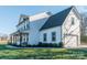 Side view of a two-story home with black trim, garage, front porch, and well-manicured lawn at 5413 Austin Rd # 4, Monroe, NC 28112