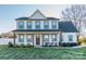 Charming two-story home with a covered front porch, well-maintained lawn, and attractive landscaping at 5413 Austin Rd # 4, Monroe, NC 28112