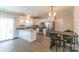 Bright kitchen with stainless steel appliances, granite countertops, white cabinetry, and an adjacent dining area at 5413 Austin Rd # 4, Monroe, NC 28112