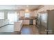 Well-lit kitchen features stainless steel appliances, granite countertops, and a breakfast bar for quick meals at 5413 Austin Rd # 4, Monroe, NC 28112