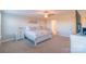 A bright main bedroom features an ensuite bathroom, neutral walls and carpet, plus a ceiling fan at 5413 Austin Rd # 4, Monroe, NC 28112