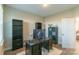An office area with hardwood floors, neutral walls, multiple shelves, a large desk and chair at 5413 Austin Rd # 4, Monroe, NC 28112