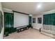A comfortable theater room with a large screen, couch, and dark green curtains at 5413 Austin Rd # 4, Monroe, NC 28112