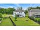 Aerial view of a fenced backyard, featuring a screened patio, lush lawn, and solar panels on the home at 6416 Willow Pin Ln, Huntersville, NC 28078