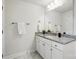 Bathroom vanity with granite countertop, white cabinets, and a large mirror at 6416 Willow Pin Ln, Huntersville, NC 28078