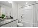 Bathroom with tub, shower combo, granite vanity, and white cabinets at 6416 Willow Pin Ln, Huntersville, NC 28078