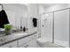 Bathroom featuring granite counters, white cabinets, a shower with glass doors, and modern fixtures at 6416 Willow Pin Ln, Huntersville, NC 28078